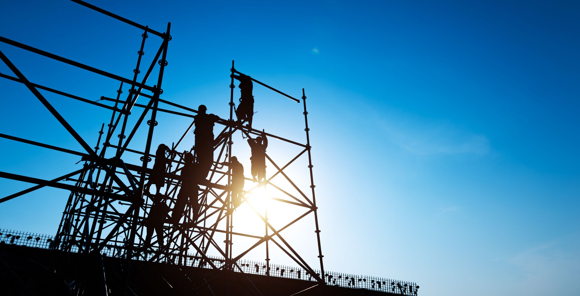 Group of construction workers working on scaffolding